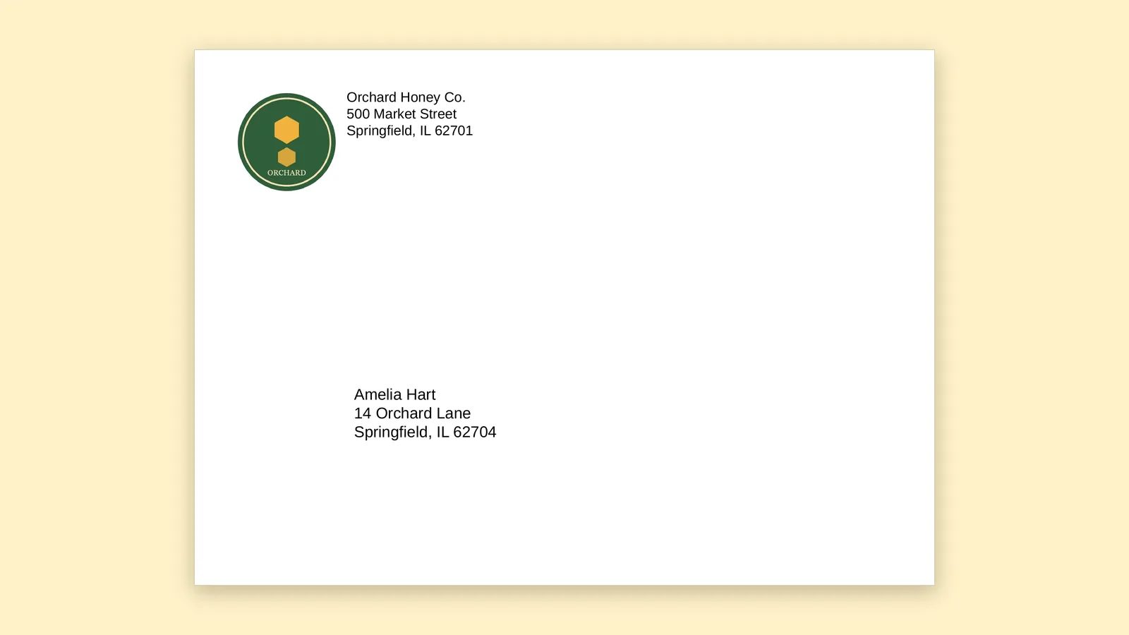 A printed envelope with a round logo and return address in the top left corner and the recipient address lower in the middle.